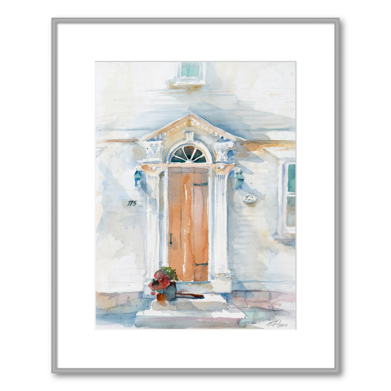 Framed artwork of a watercolor painting of a house exterior with a front door.